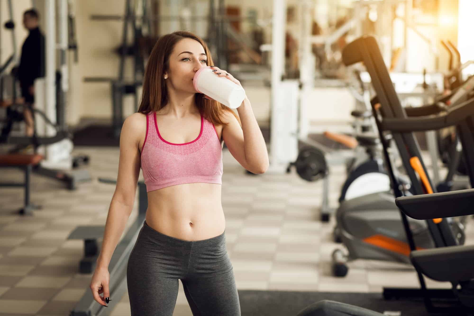 Woman taking pre workout drinks