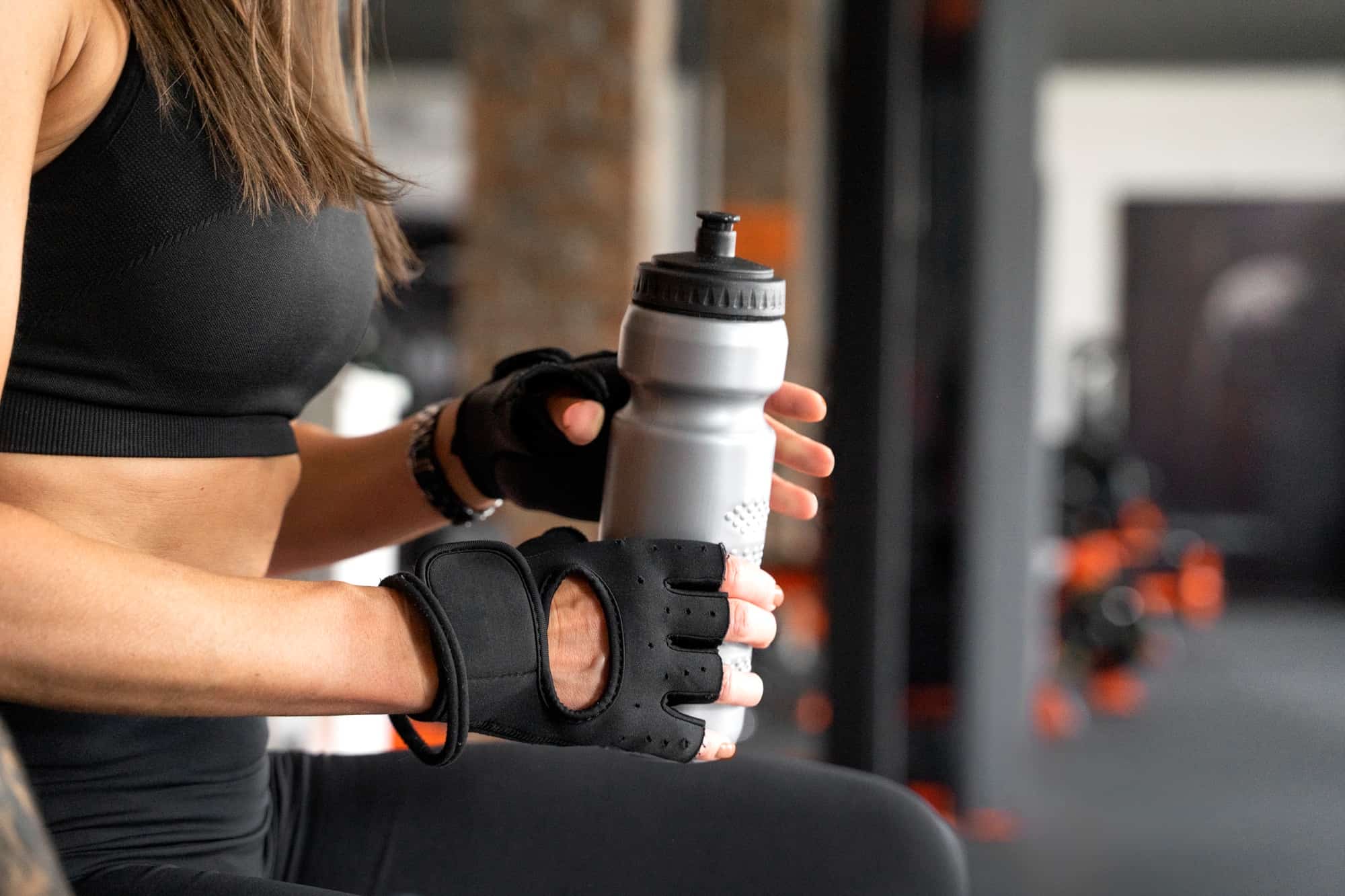 woman holding a bottle at gym